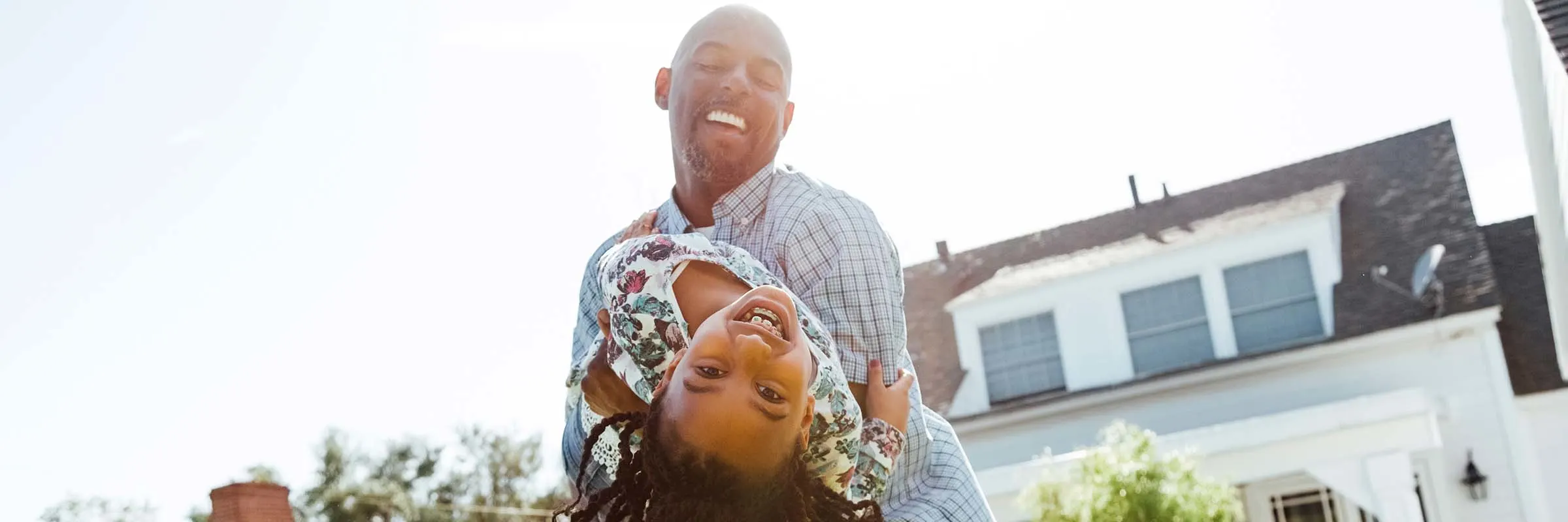 Father and daughter playing in back yard