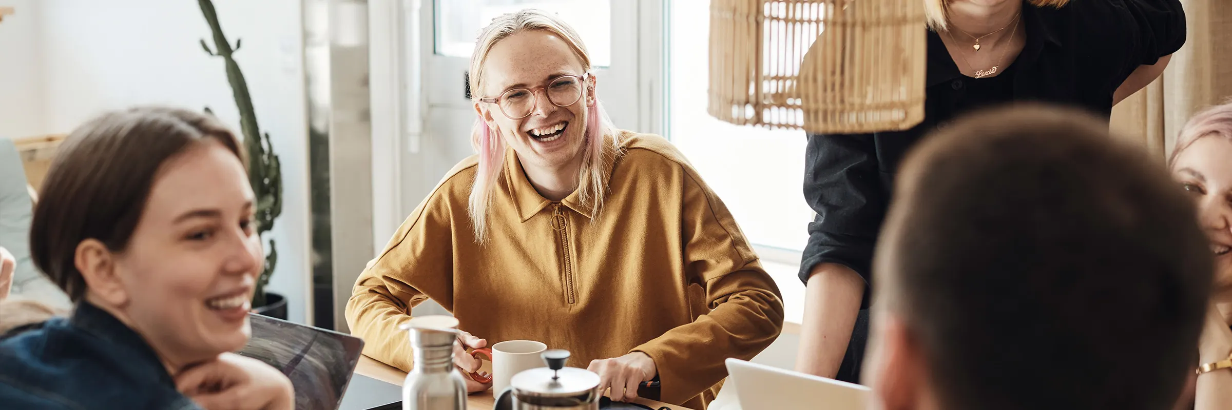 A group of colleagues have coffee together.