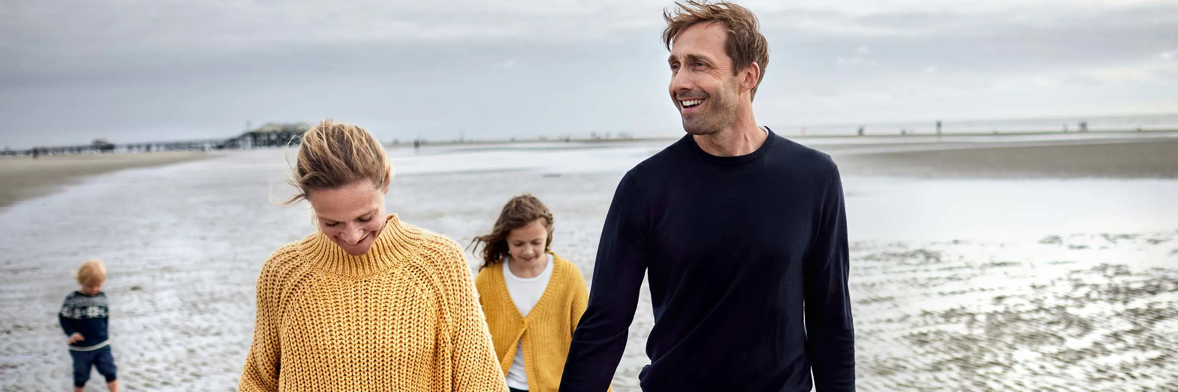 Family walking together on the beach