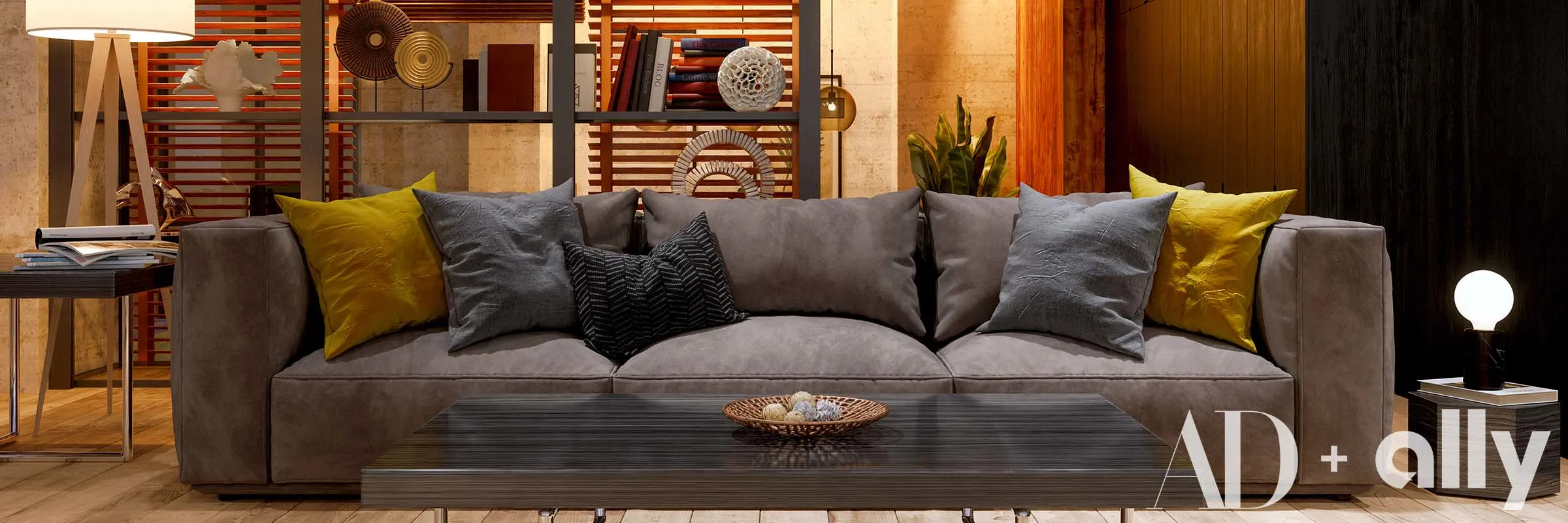  A trendy living room setup with a grey couch and throw pillows, styled bookshelves and decorative lamps.