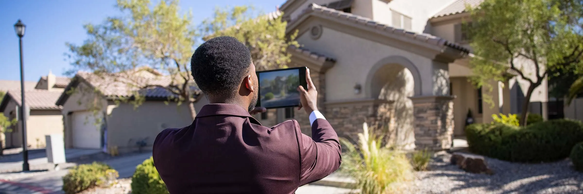 Man taking picture of a house.