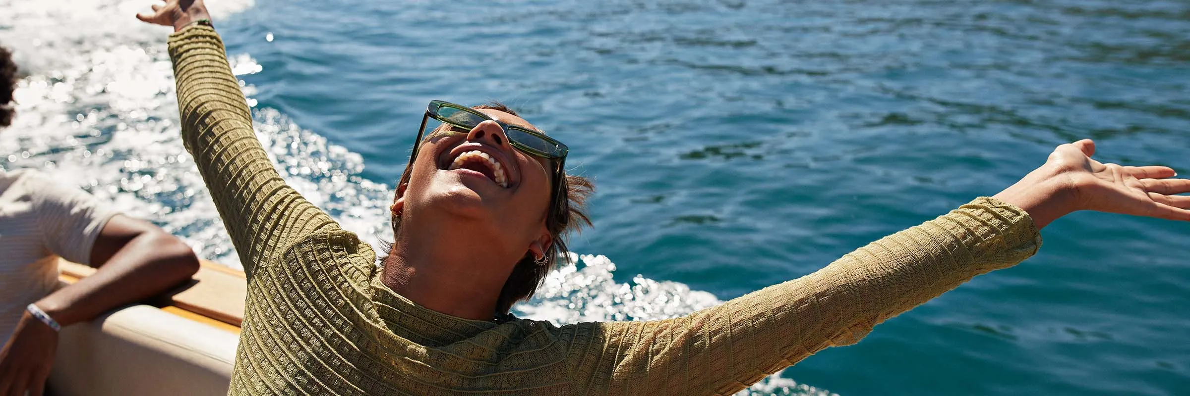 Happy woman on a boat while on vacation