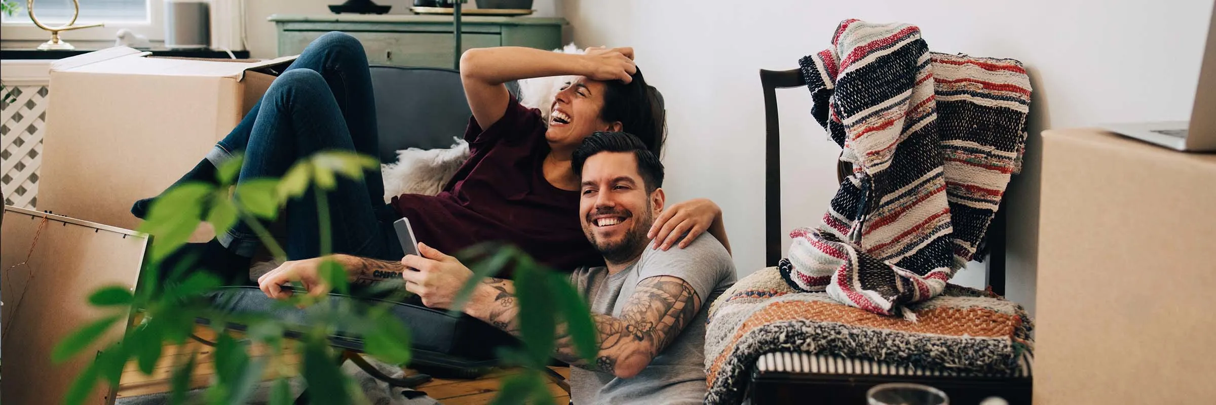 A happy couple taking selfies in their new home.