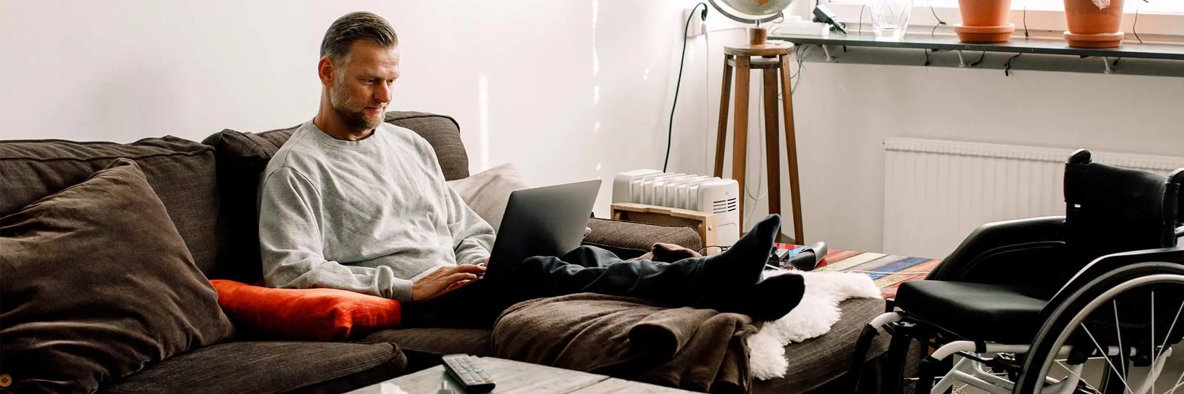 A man working on his laptop in his apartment