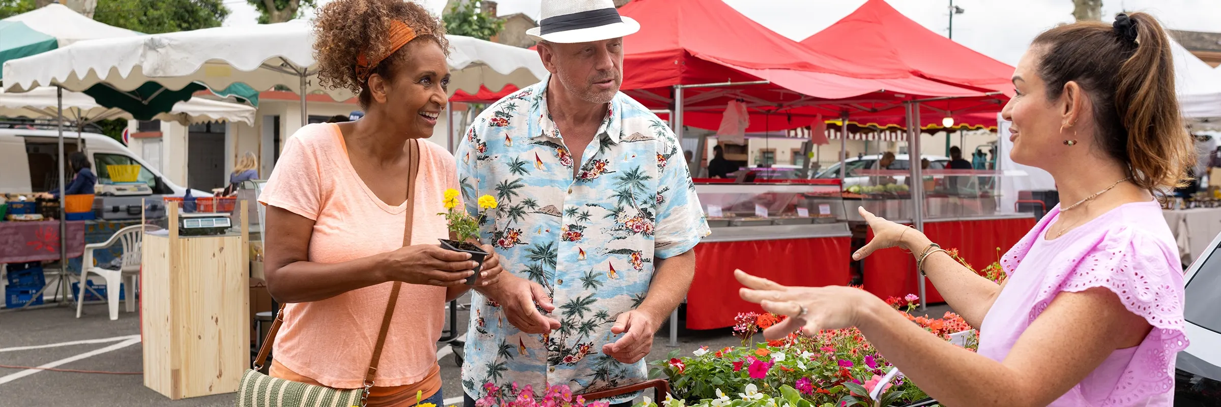 Mature couple shopping at an outdoor farmers market.