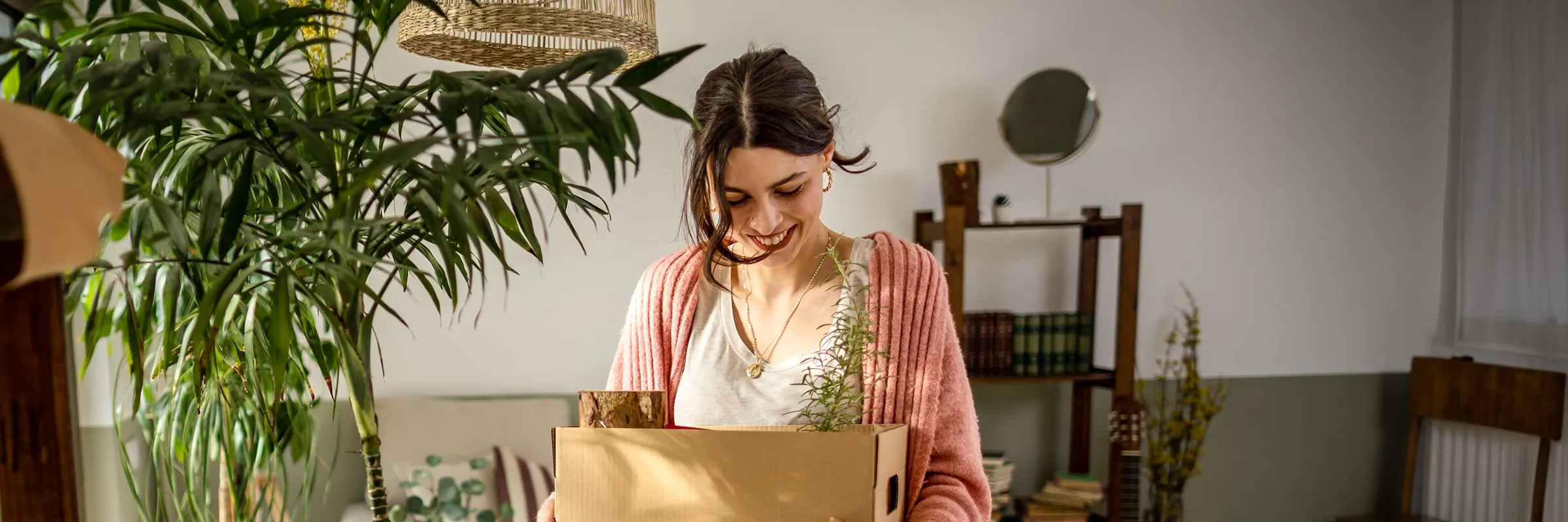 Woman moves houseplants into a new home