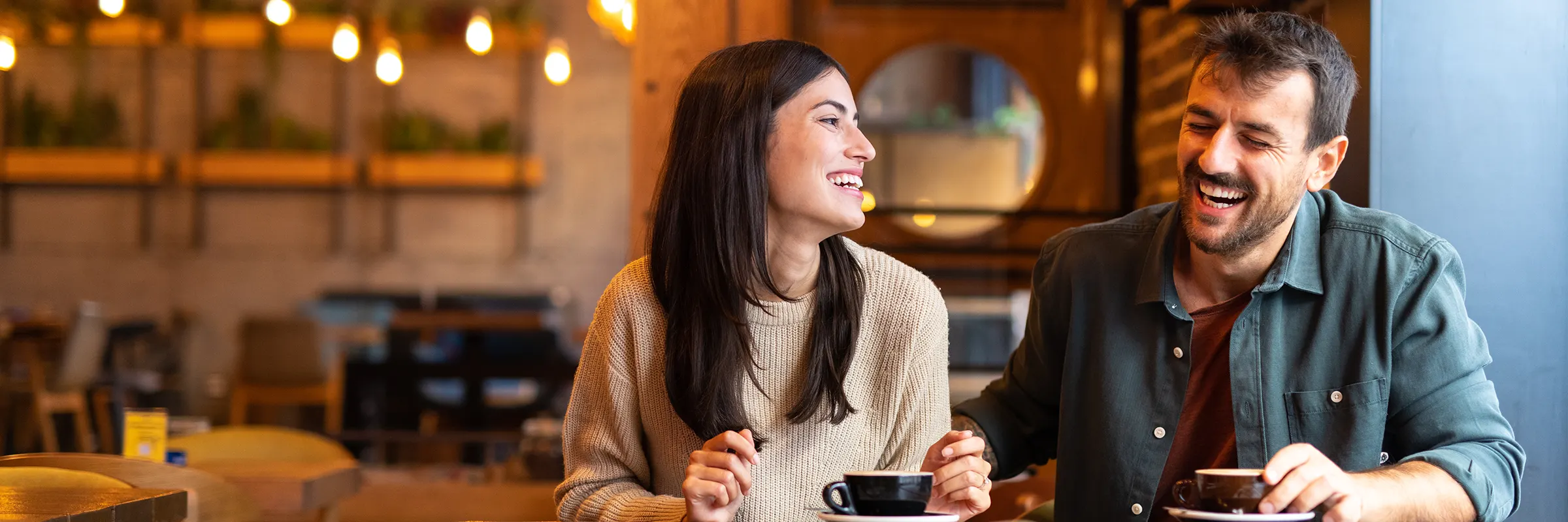A couple enjoying coffee together at a café