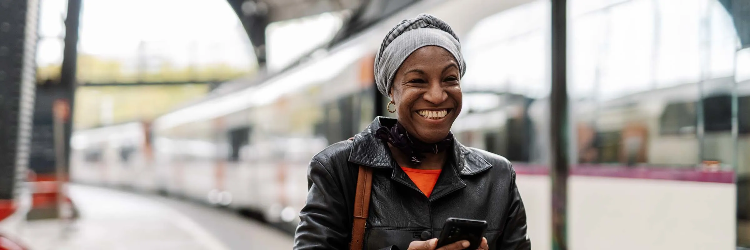 Female traveling solo smiling at the train station