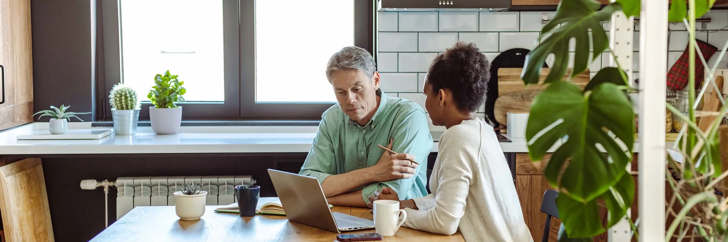 Couple sitting at their kitchen table reviewing their accounts and having a serious conversation