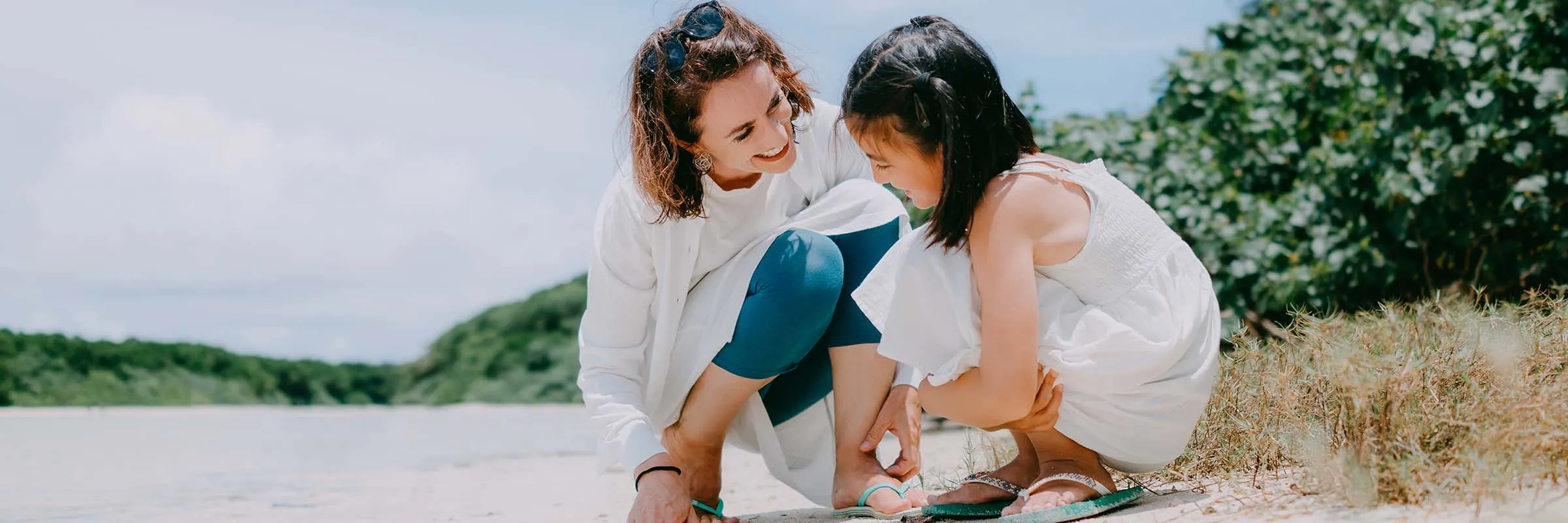 Mother and child playing on beach 