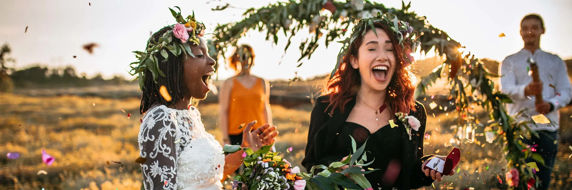 Two brides celebrating after their outdoor ceremony