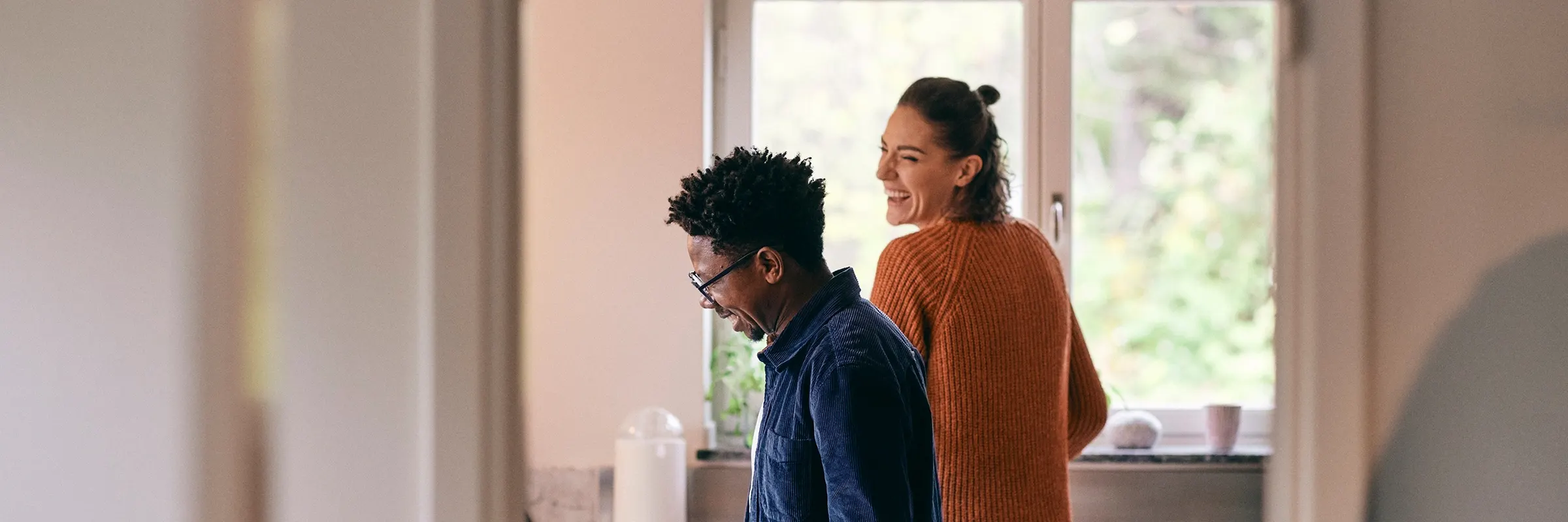 A couple cleans up their kitchen together