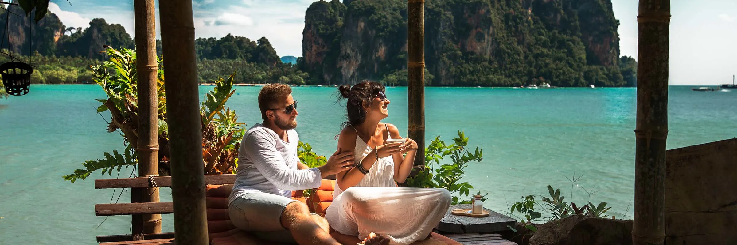 Man and woman relax in cabana by the water