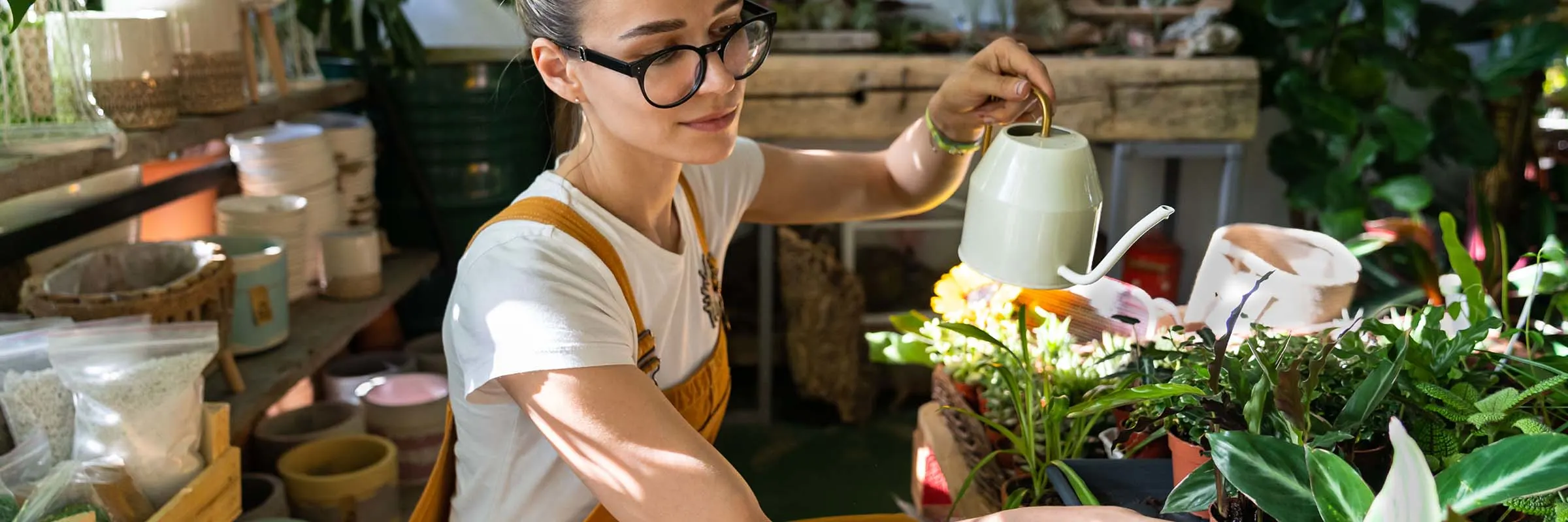 A woman watering her plants. 