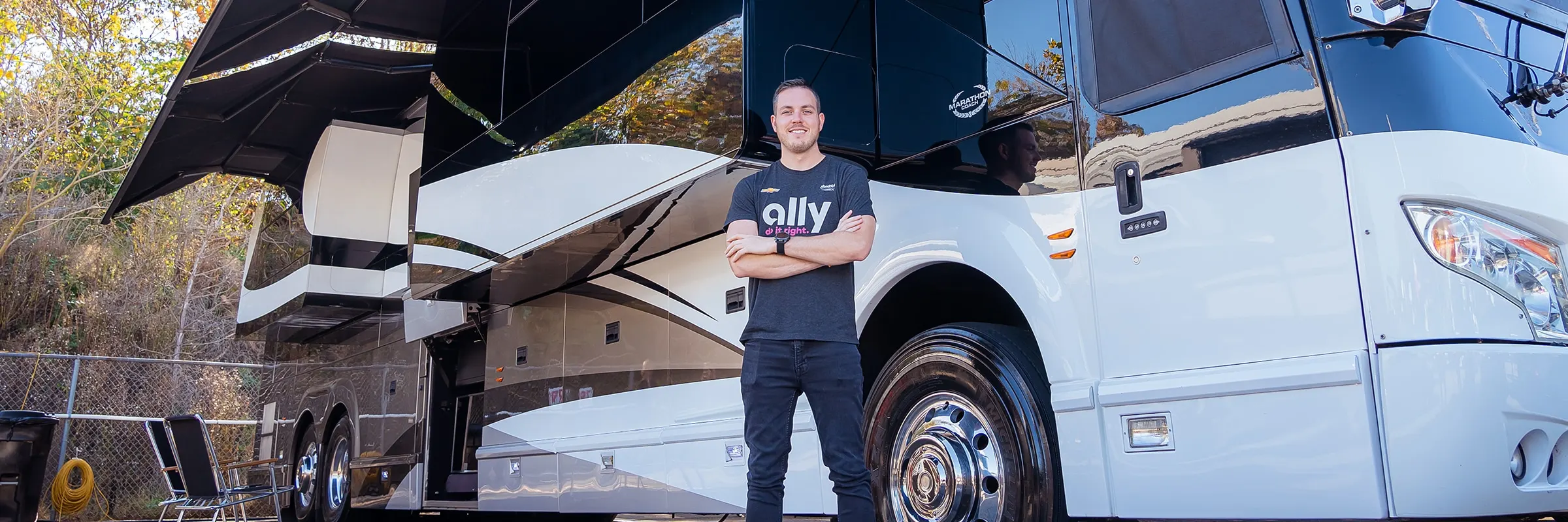 Alex Bowman stands outside of his Prevost tour bus