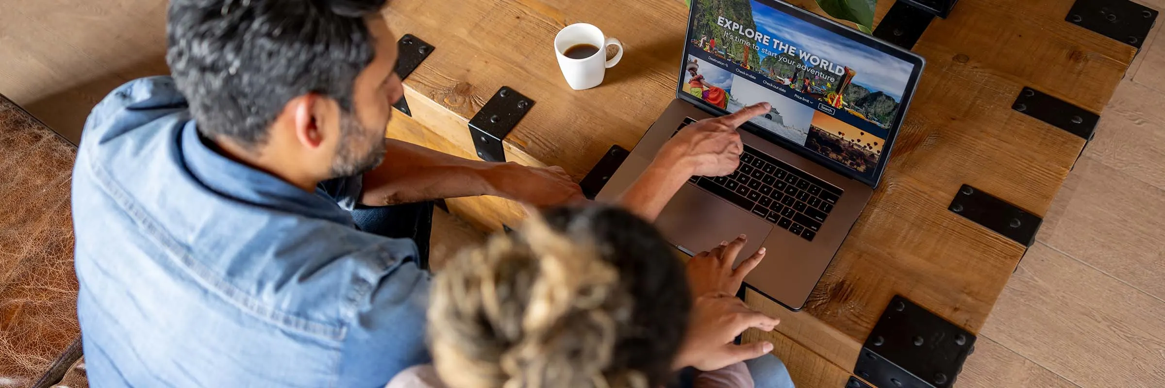 couple at home booking a trip online using their laptop computer