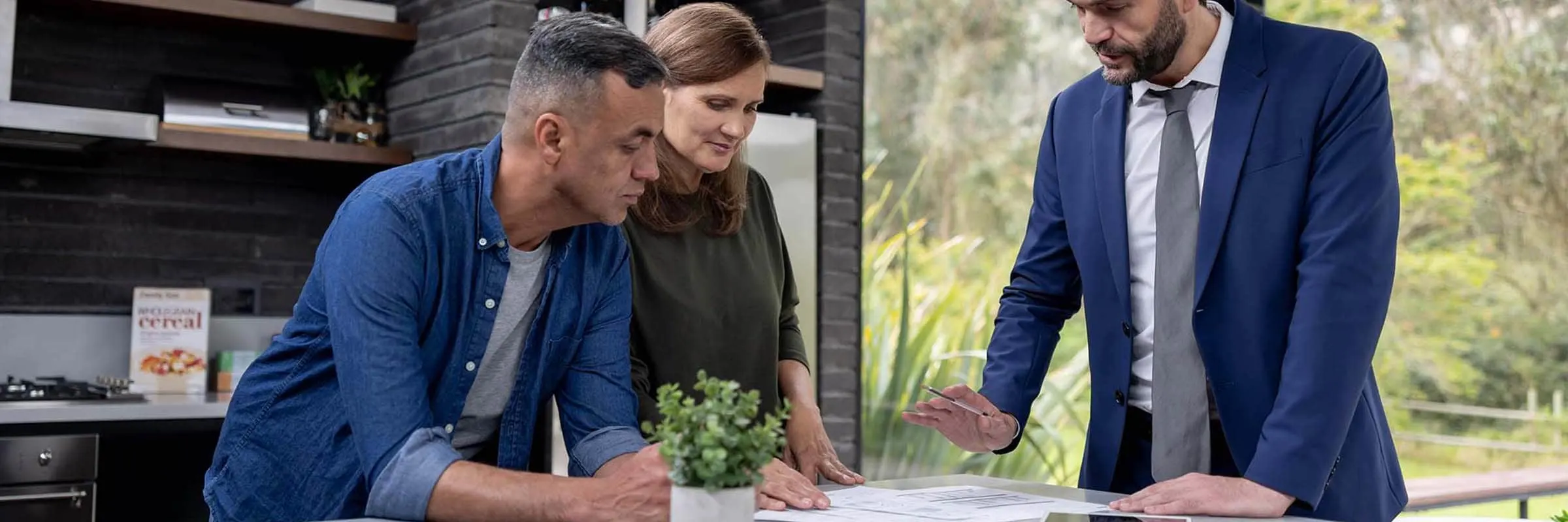 Advisor talking to a couple in their home.