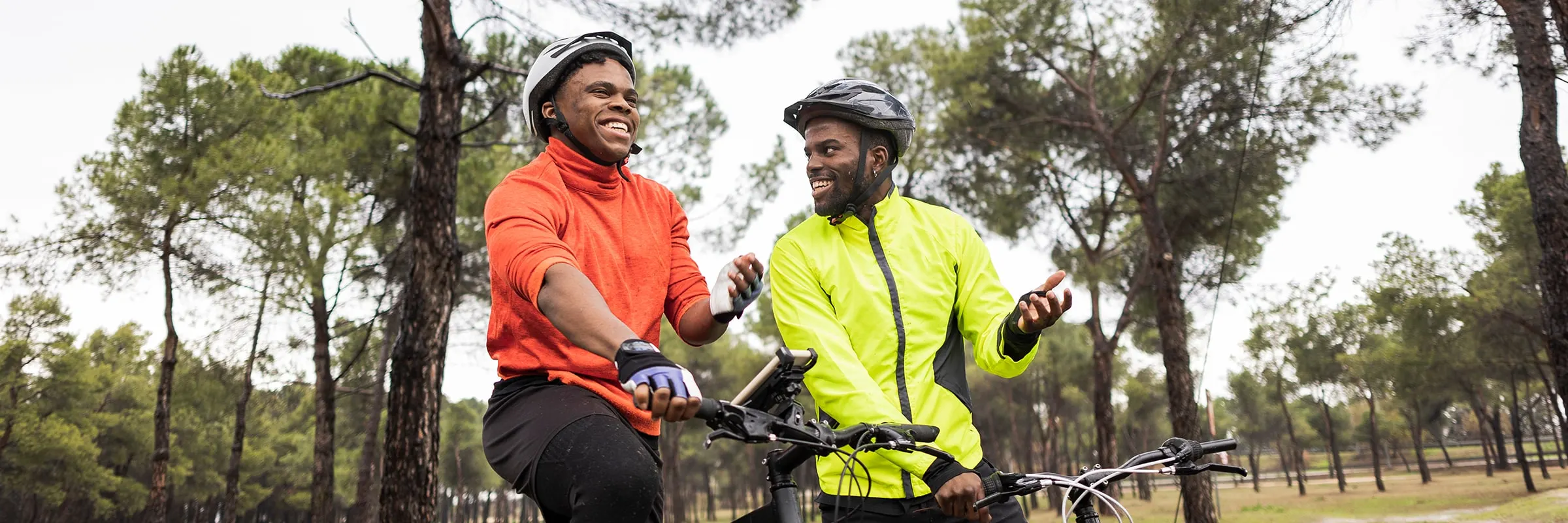 Two men ride bikes on a trail