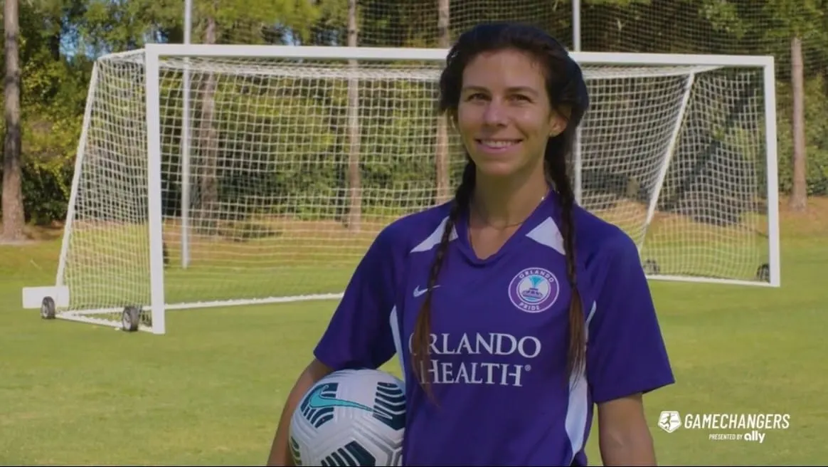 Soccer player Erika Tymrak poses in front of a soccer goal as a NWSL and Ally Game Changer