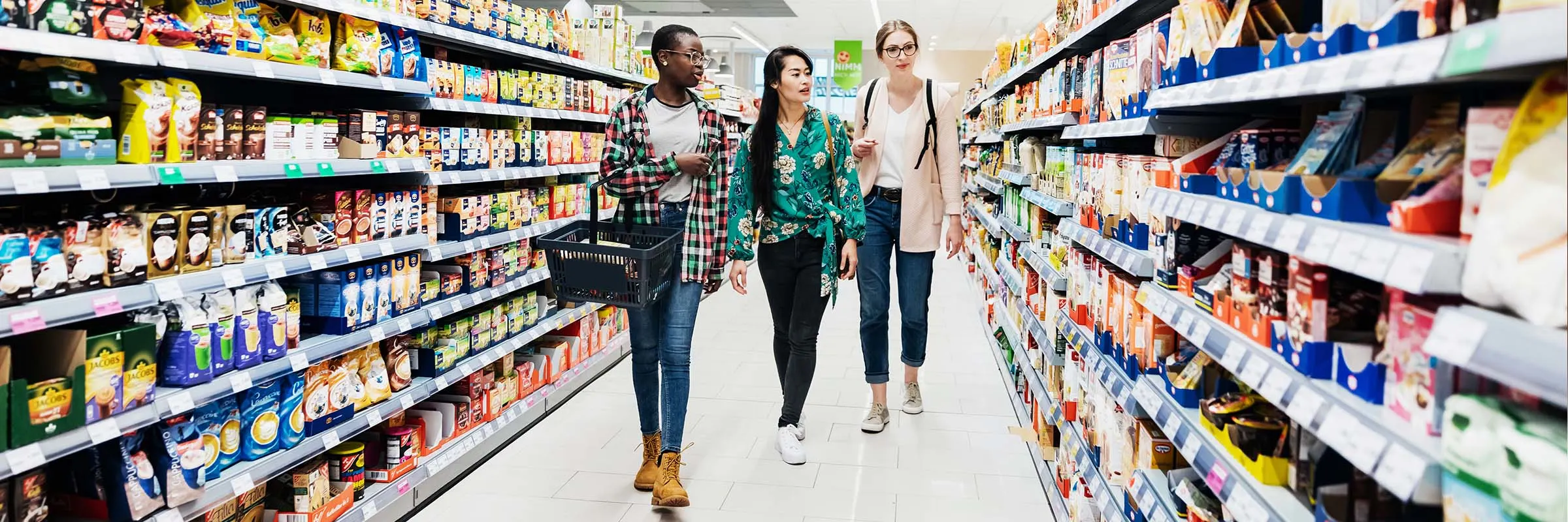 Three girls shopping in supermarket