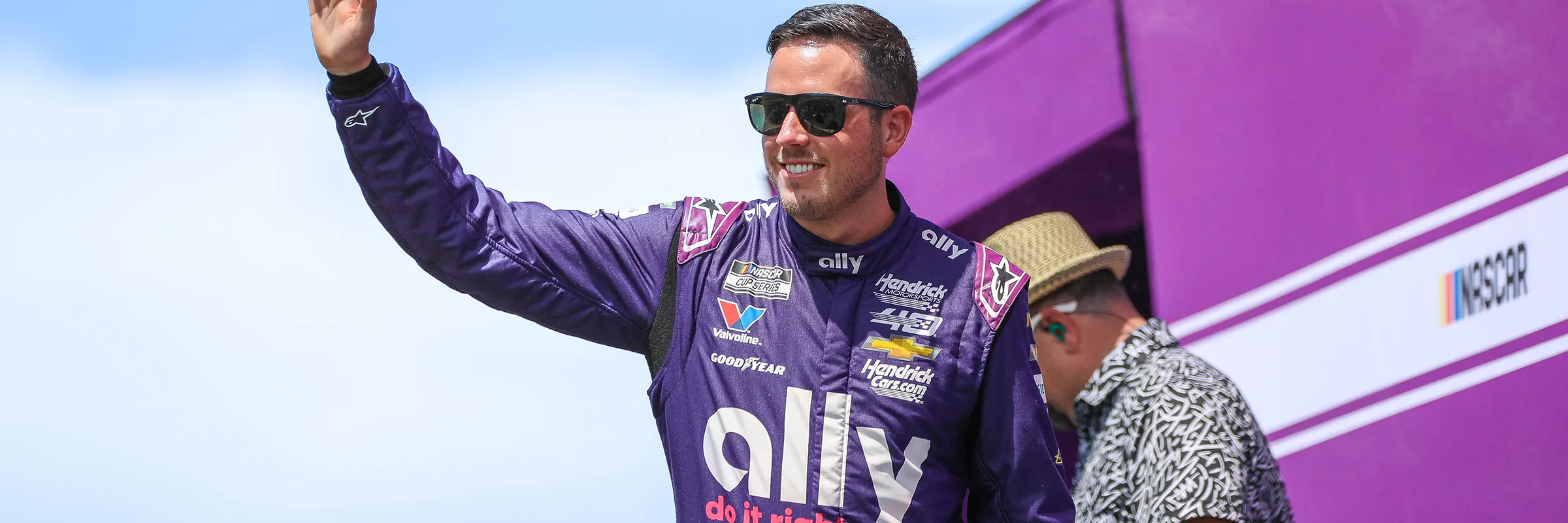 Nascar driver of the Ally #48, Alex Bowman, wears his Ally fire suit and waves to the crowd before a race.