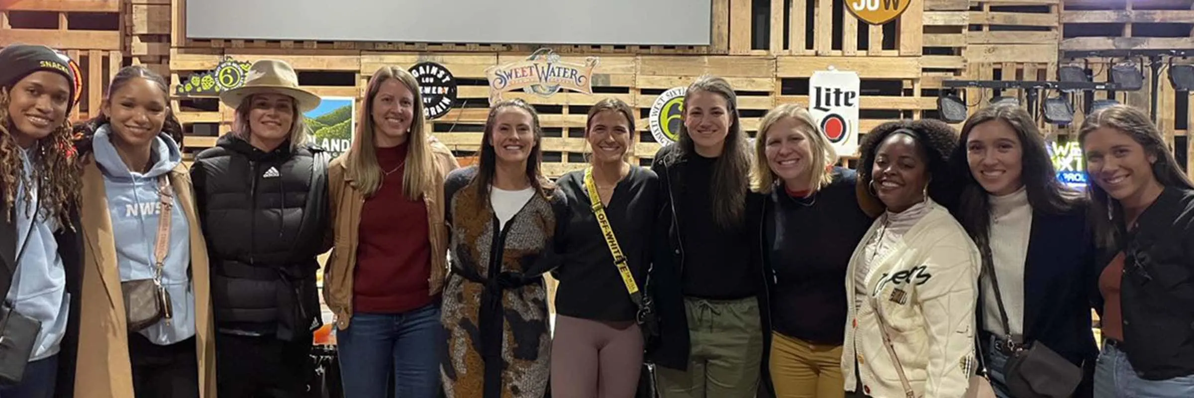 Meghann Burke poses with members of the National Women's Soccer League