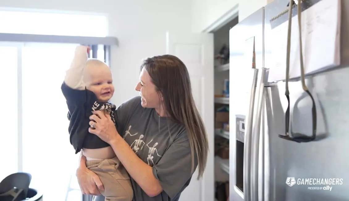 Soccer player, Arin Wright, poses with her son