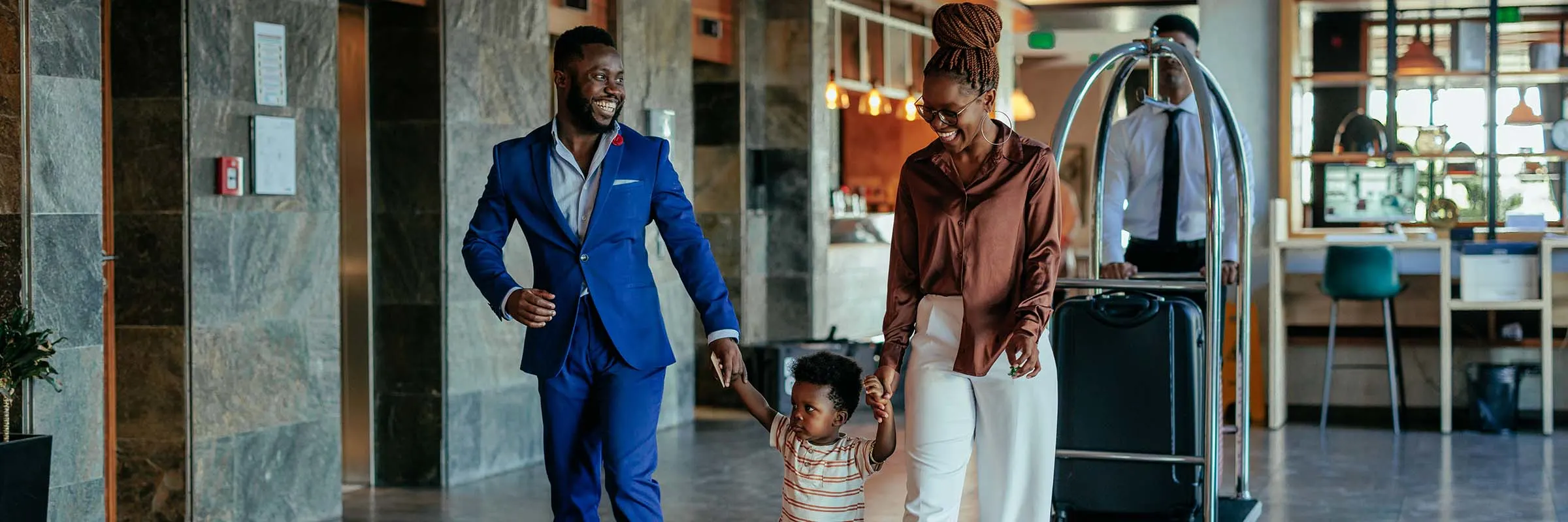 Family walking through a hotel with their luggage