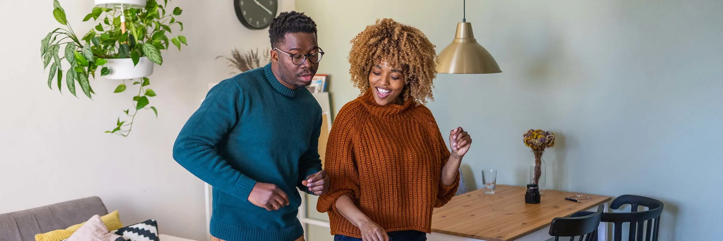 couple dancing in their trendy apartment 