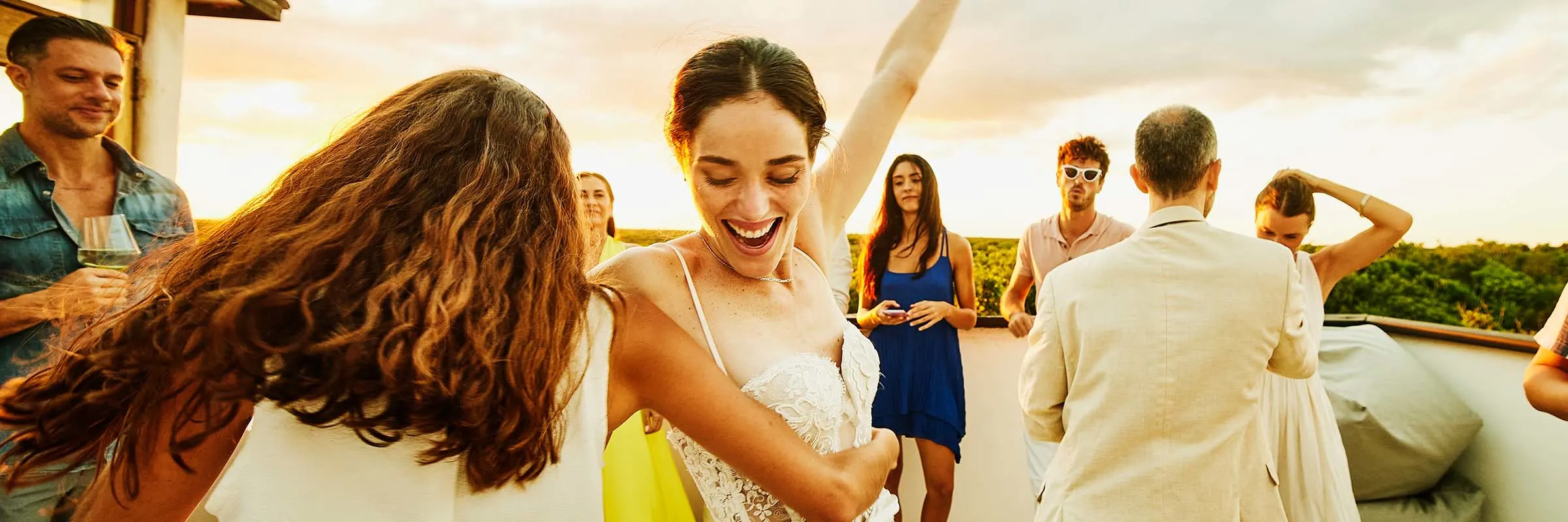 Bride is dancing, and wedding guests are watching.