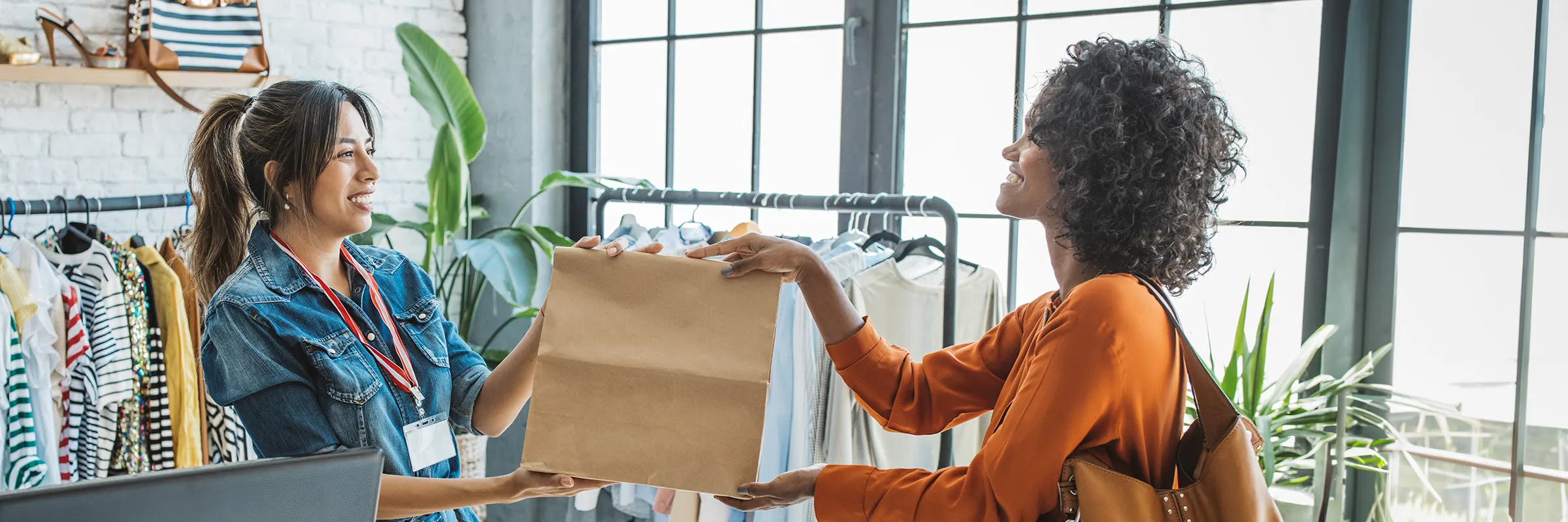 Woman smiling while making a purchase at a retail store. 