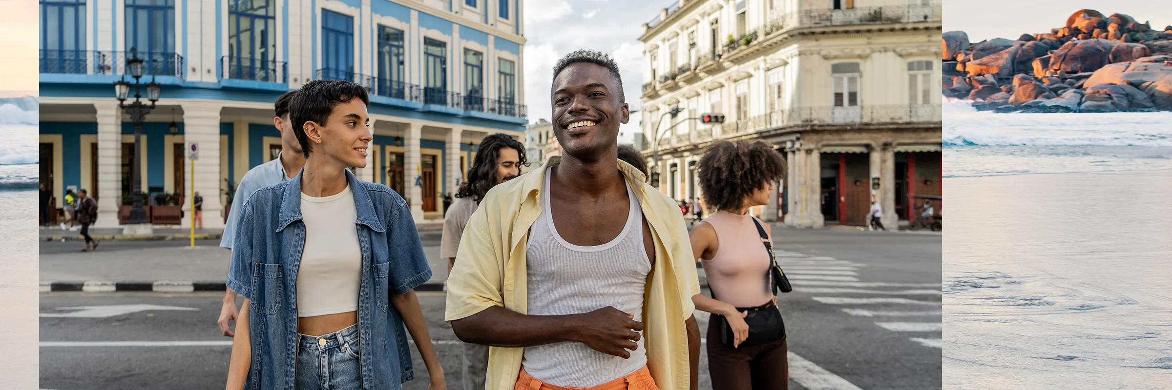 A group of young people on vacation happily walk through a city. 