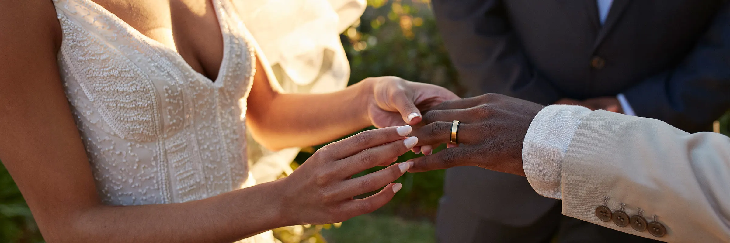 Young bride exchanging wedding ring with groom