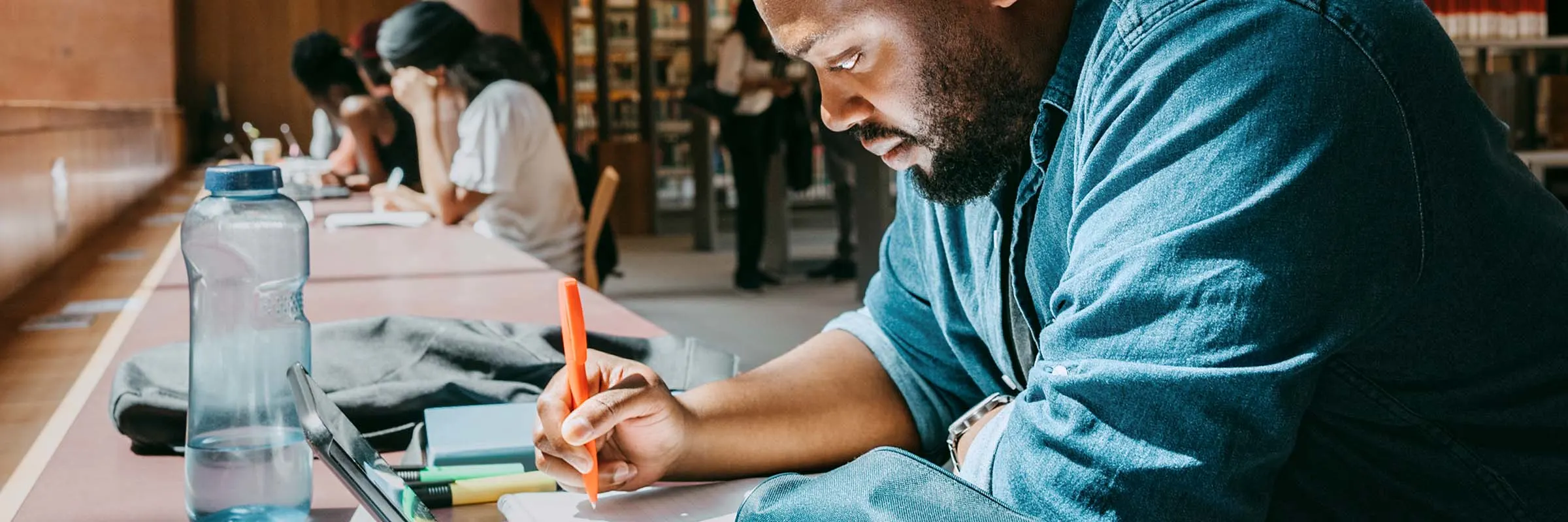 Image of a man studying in a library