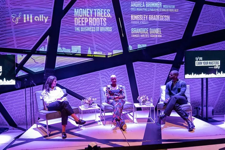 Kingsley Gbadegesin joins Andrea Brimmer and Brandis Daniels on stage during the Ally and Earn Your Master’s panel at New York Fashion Week. 