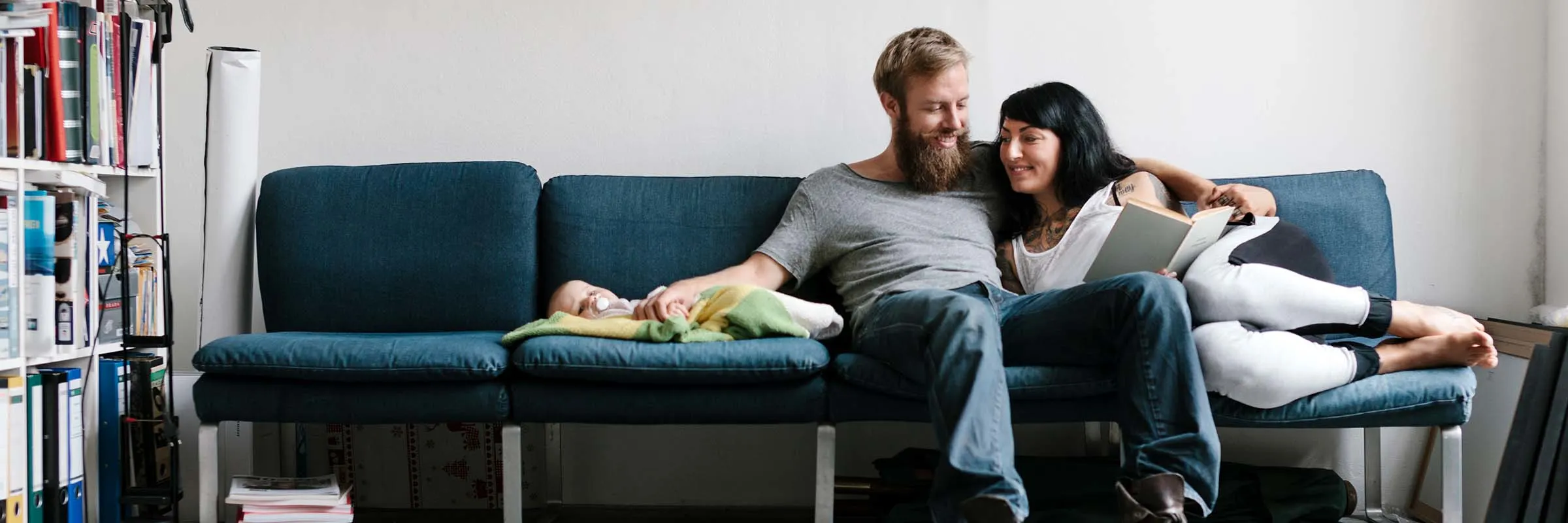 young couple relaxing with their newborn baby