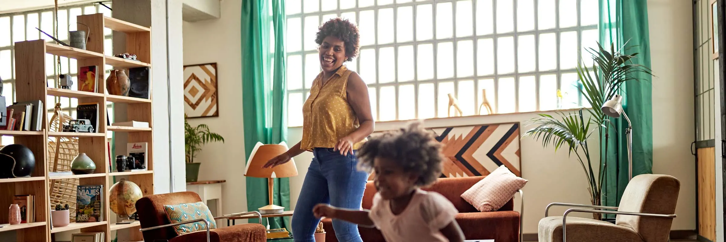 Mother and daughter dancing at home.