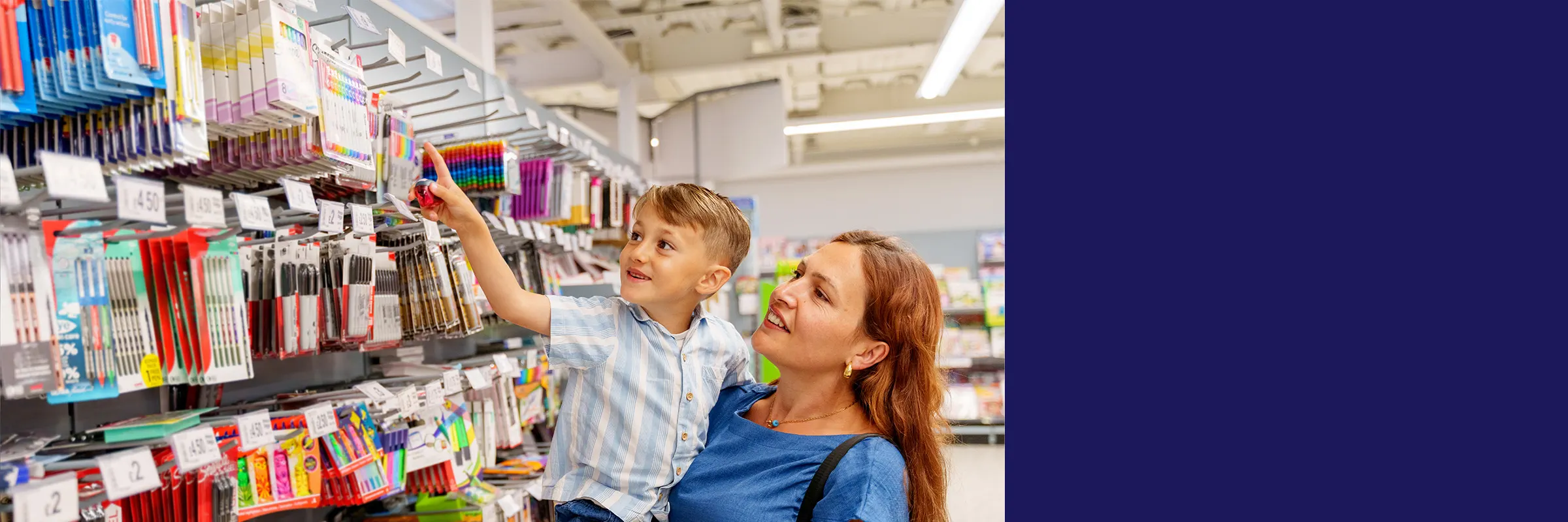 Mother and child shop for school supplies in a store. 