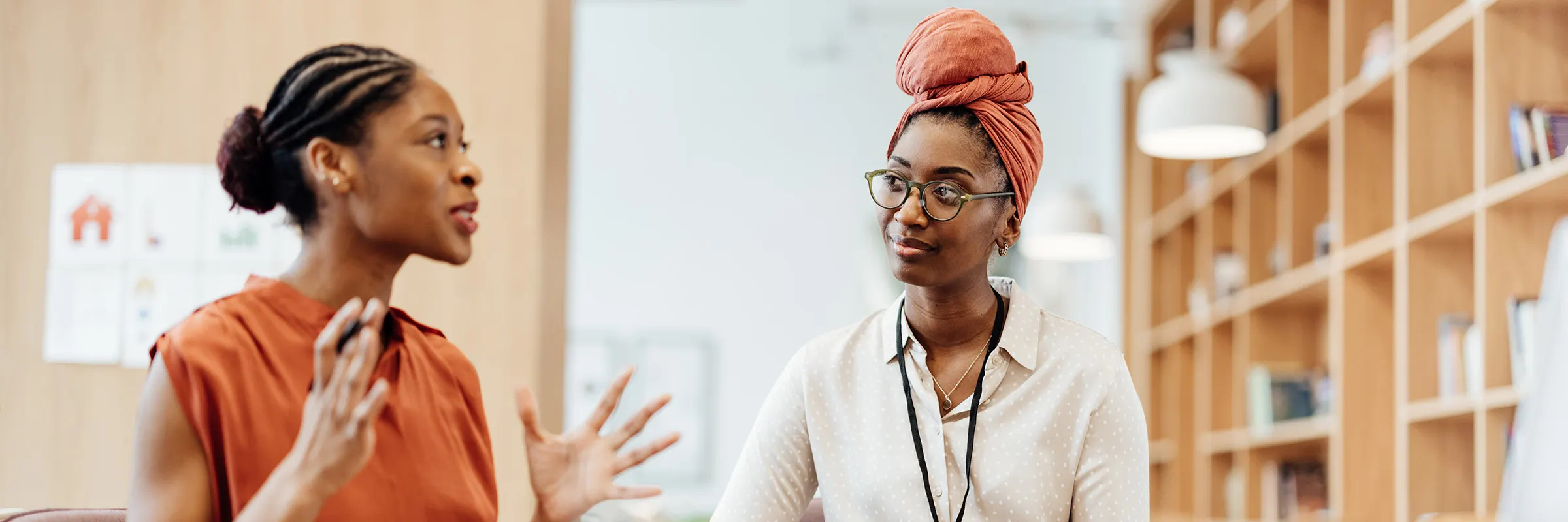 Two people having a discussion while sitting. 