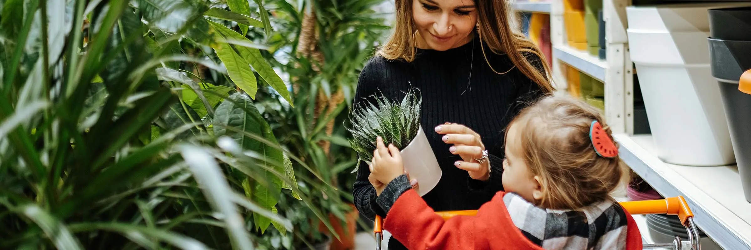 Woman plant shopping with her daughter