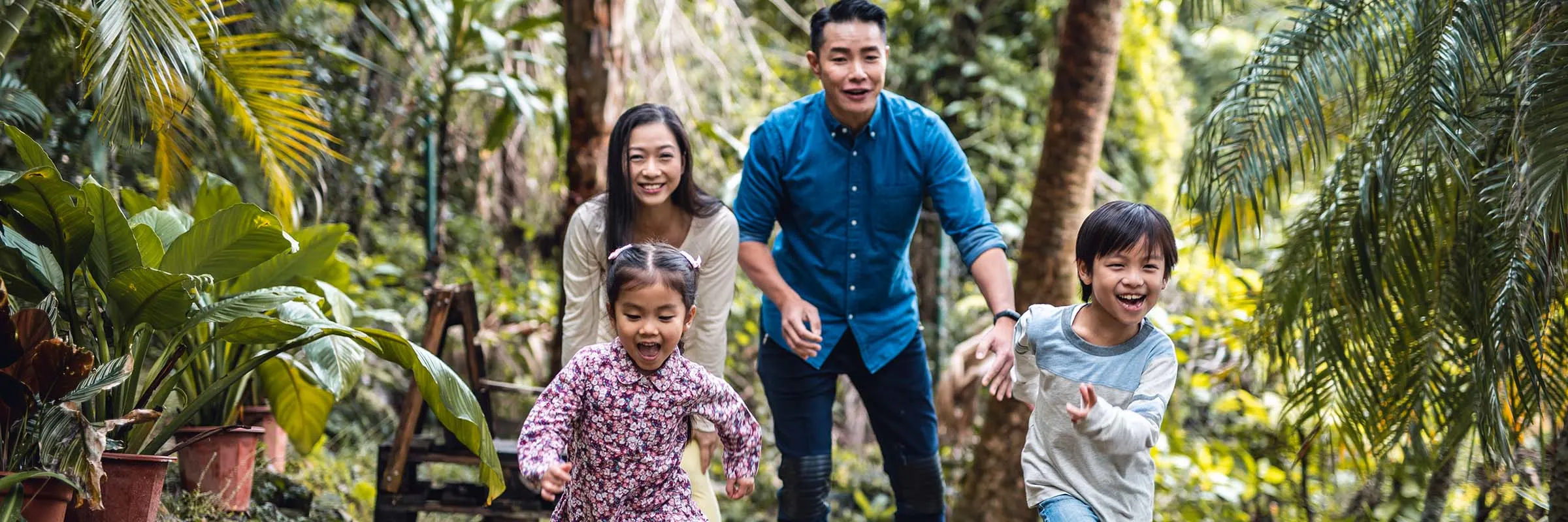 Two kids running in front of their parents