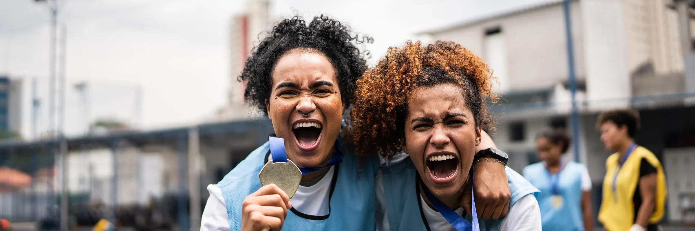 Female soccer players celebrate a gold medal win.