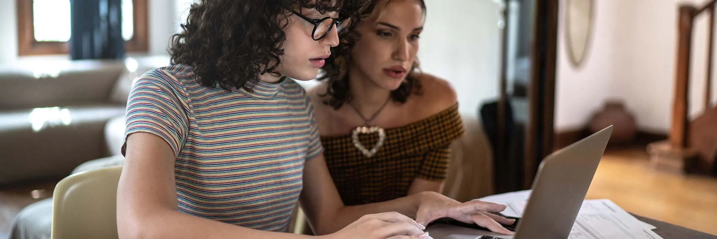 women doing finances together at home