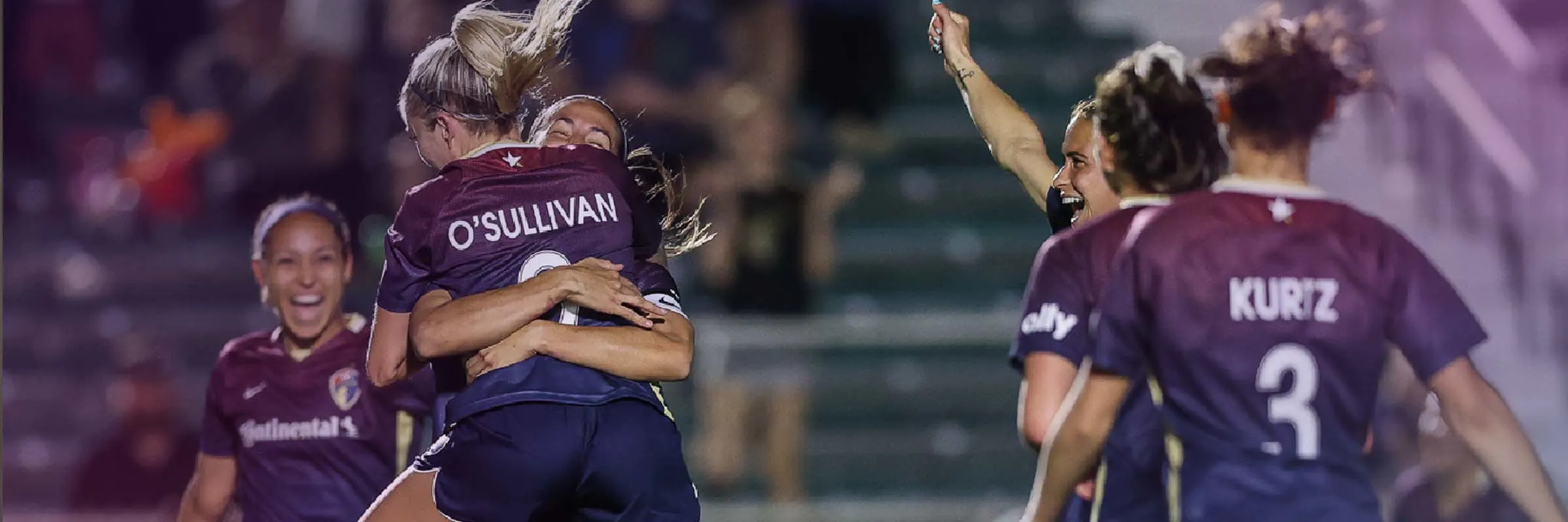 Players of the National Women&rsquo;s Soccer League celebrate on field. Text overlay: Game Changers presented by Ally.