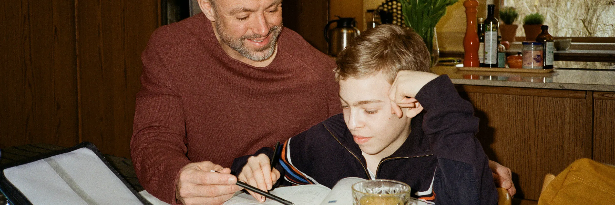 Father and son looking at homework.