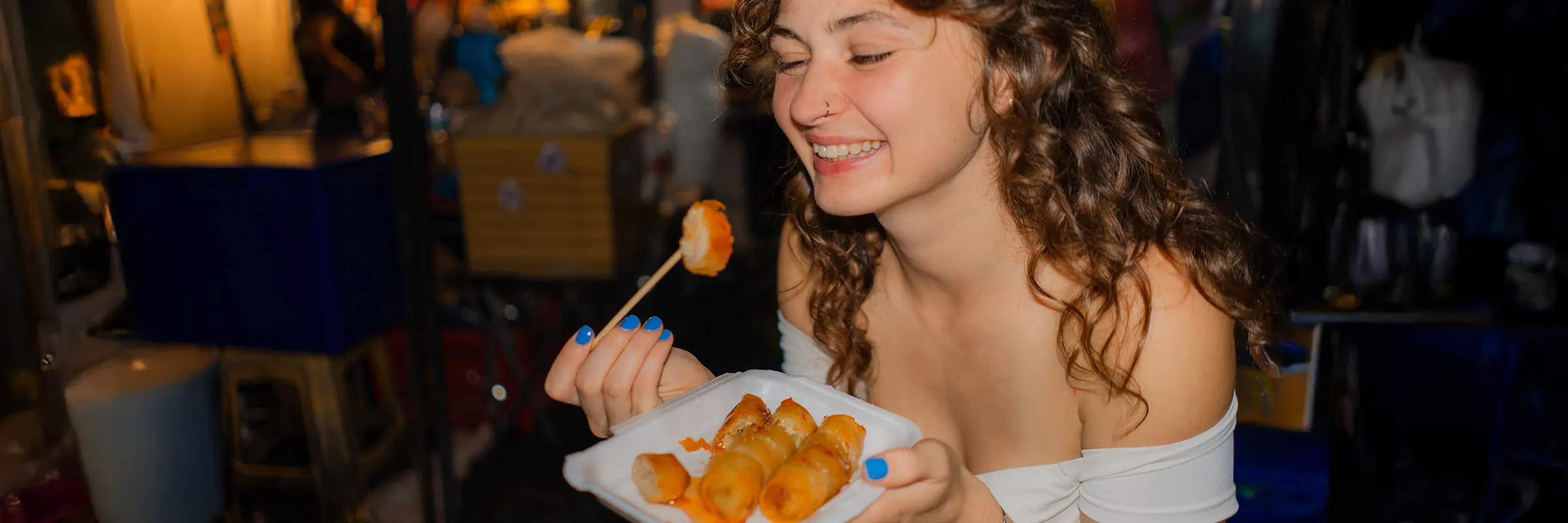 Bride eating food in her wedding dress during the reception.  