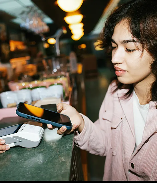 Person using their mobile phone for payment at a cafe. 