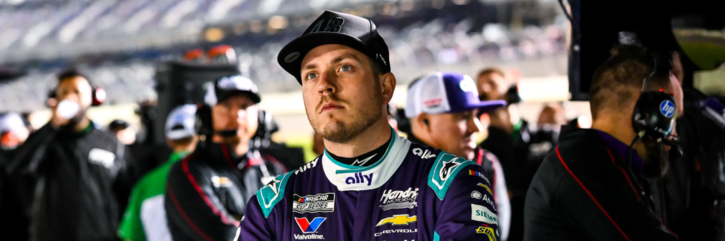 Alex Bowman looks out from the pit area before a NASCAR race