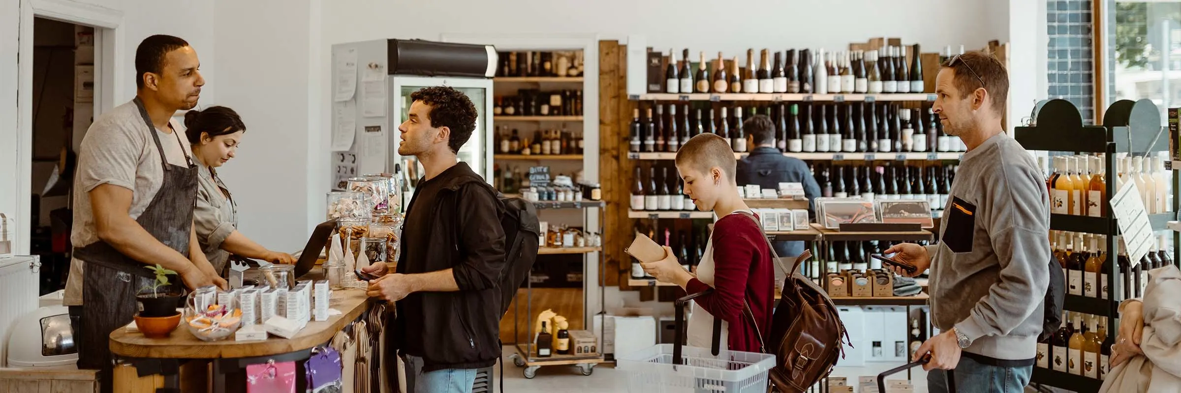 Customers standing in queue while doing shopping in store