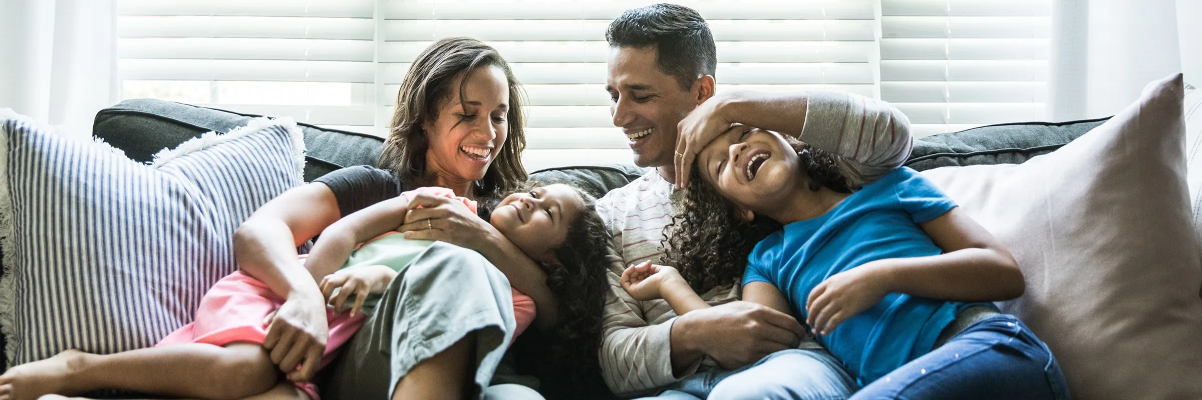 A young family relaxes on the couch